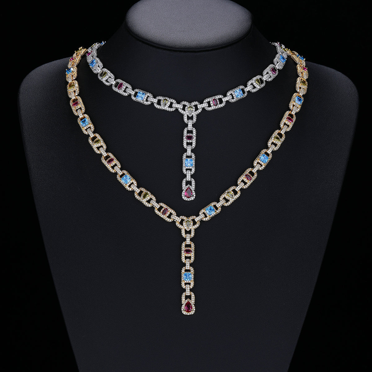 Silver- and gold-tone multicolor lariat necklaces displayed on a black bust