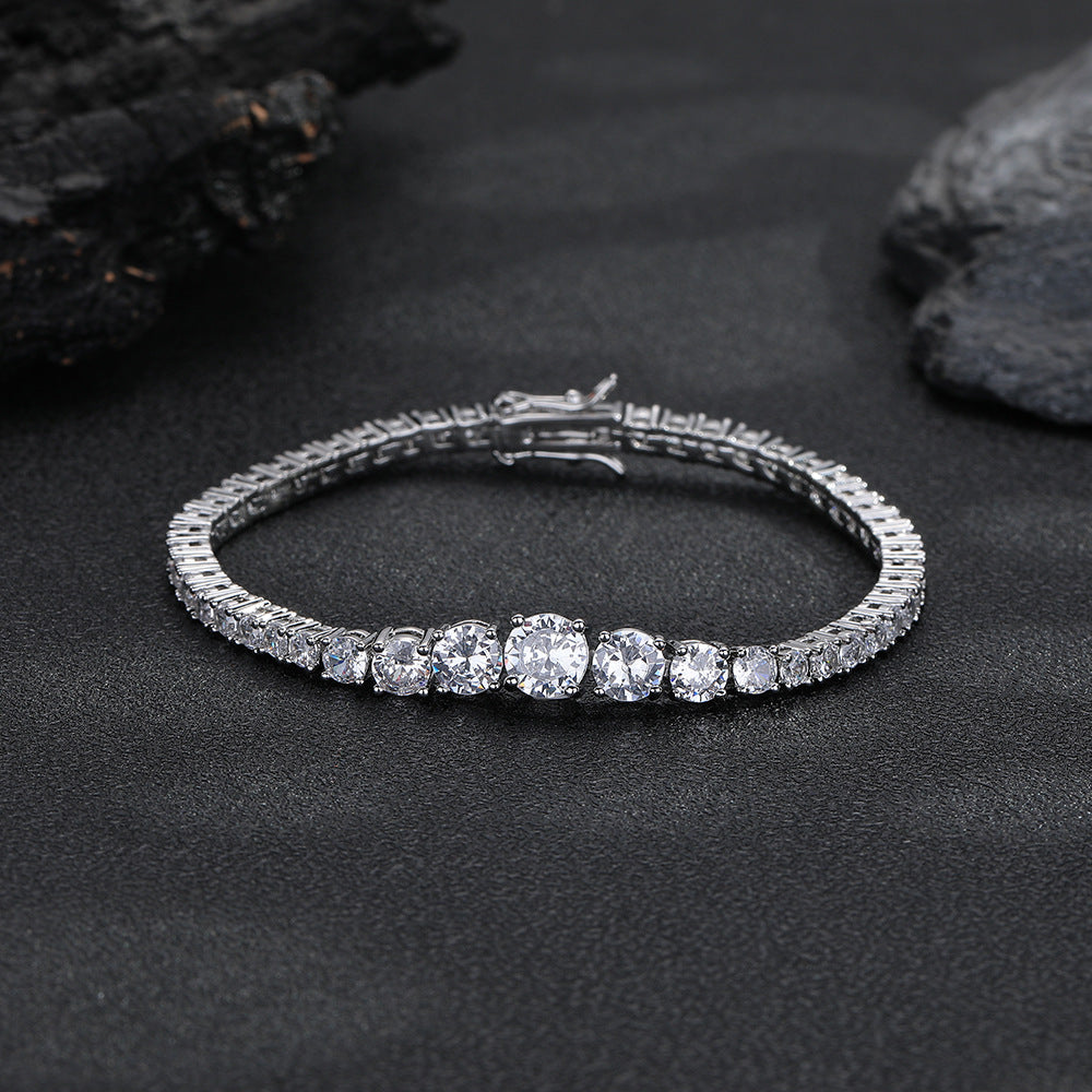 Silver-tone graduated tennis bracelet with its clasp closed on a dark surface