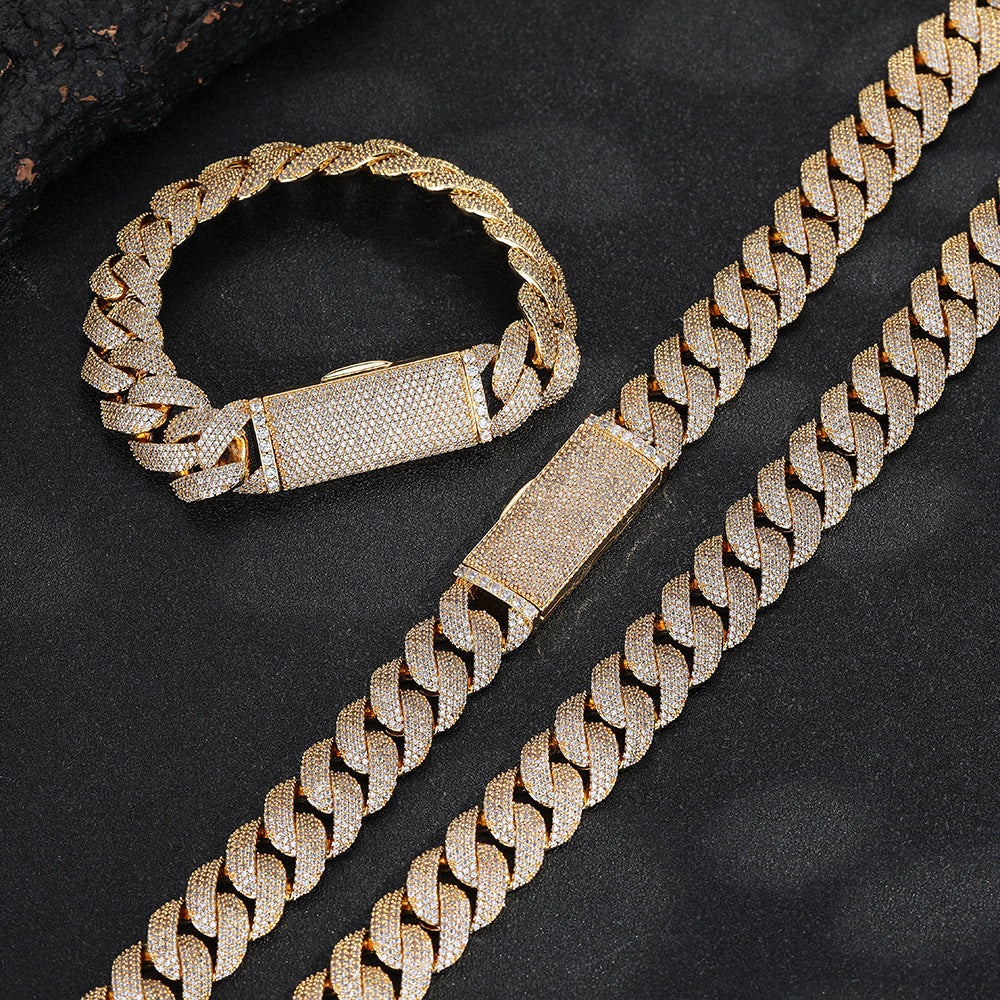 Gold-tone pavé Cuban bracelet and matching chains on a dark surface