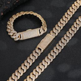 Gold-tone pavé Cuban bracelet and matching chains on a dark surface