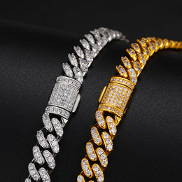 Silver and Gold moissanite Cuban links and stone-set box clasps on black fabric