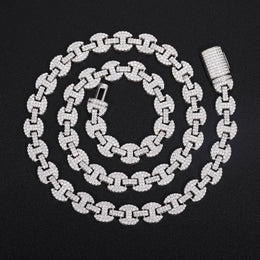 Silver-tone moissanite mariner chain in a spiral with its open clasp on black fabric