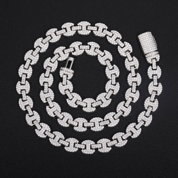 Silver-tone moissanite mariner chain in a spiral with its open clasp on black fabric
