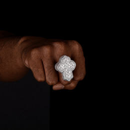 Silver 40mm cross statement ring worn by a deep-brown-skinned model