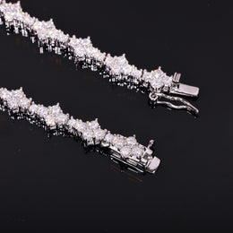 Close-up of round moissanite stones and the open box clasp on a silver-tone tennis chain