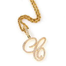 Gold-tone cubic zirconia script letter C pendant on white