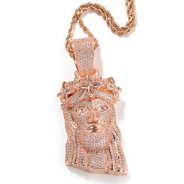 Rose gold-tone crowned portrait pendant with clear stones