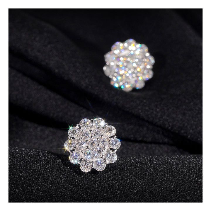 Silver-tone flower-cluster stud earrings on black fabric