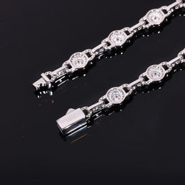 Reverse of the round halo links and box clasp beside a front-facing chain segment