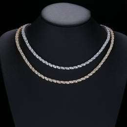 Silver- and gold-tone triangle tennis necklaces displayed on a black jewelry bust