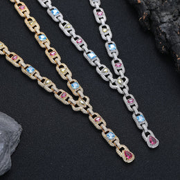 Silver- and gold-tone necklaces showing geometric links and colored stone drops