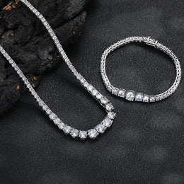 Silver-tone graduated tennis necklace and matching bracelet on dark stone