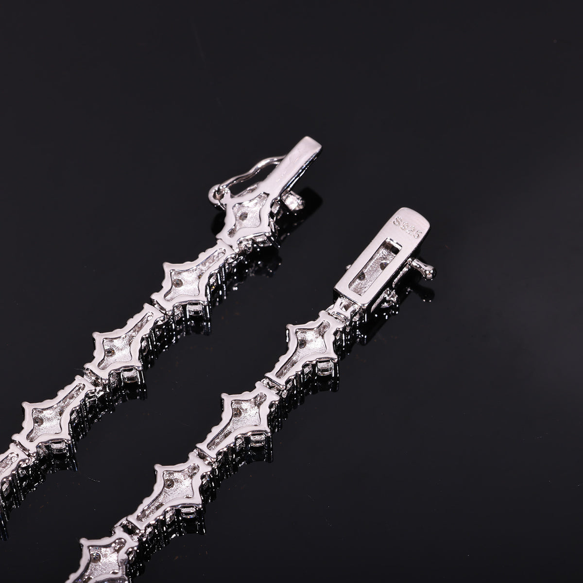 Back of angular tennis-chain settings and open clasp showing an S925 mark