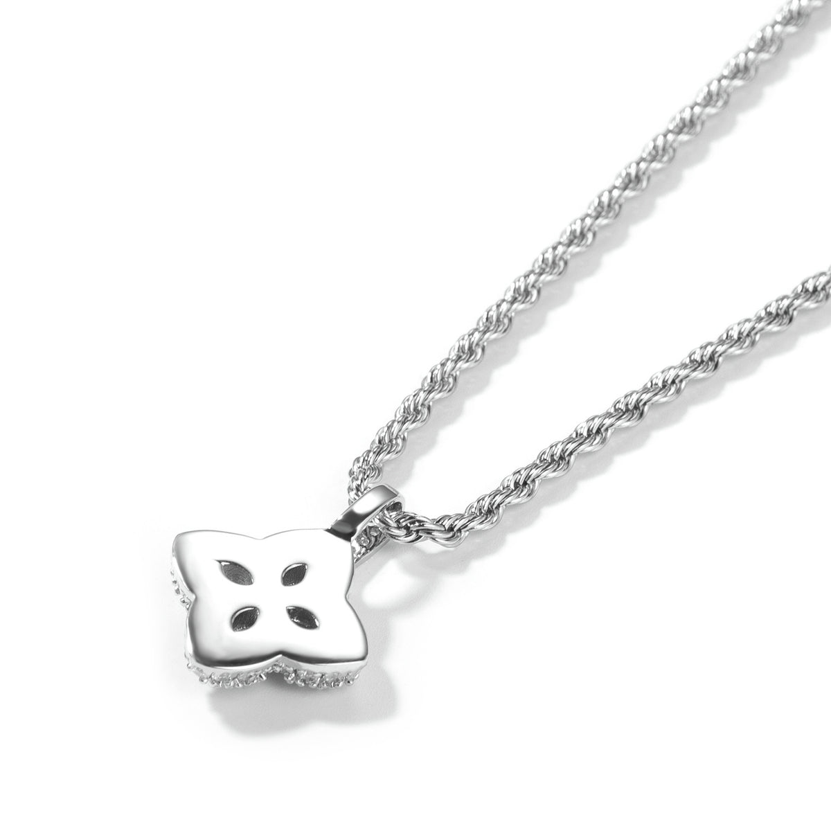 Back view of a silver-tone four-leaf clover pendant with open petal cutouts