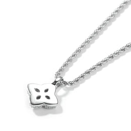 Back view of a silver-tone four-leaf clover pendant with open petal cutouts