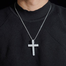 Silver iced moissanite cross pendant worn on black knit