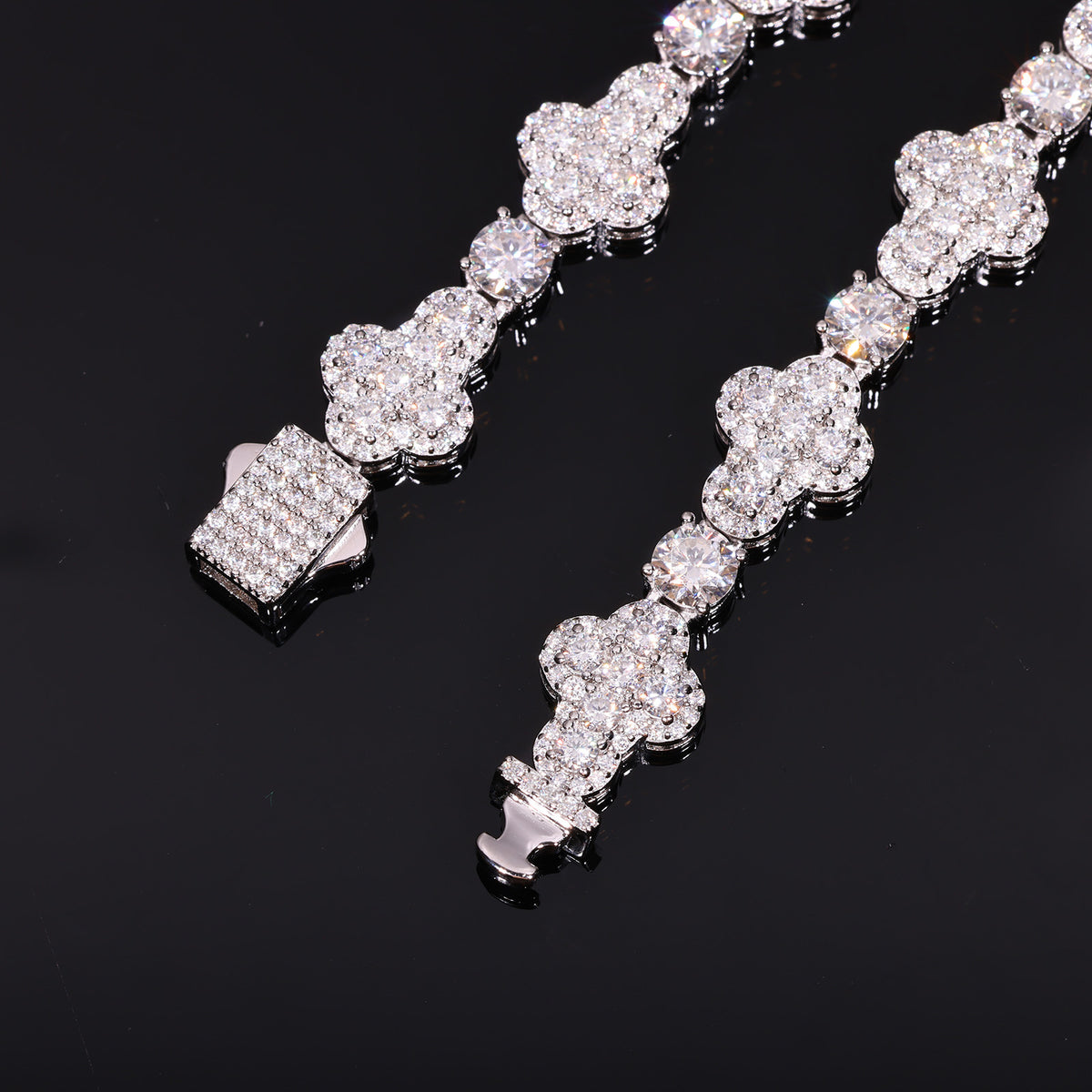 Close-up of moissanite cross links, round connector stones and the stone-set box clasp