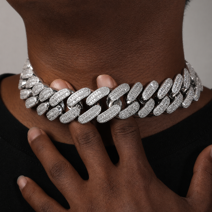 Wide silver-tone stone-set Cuban link necklace worn close to the neck