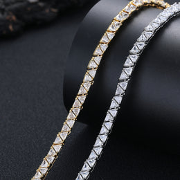 Close-up of triangular stones in silver- and gold-tone necklaces on a black bust