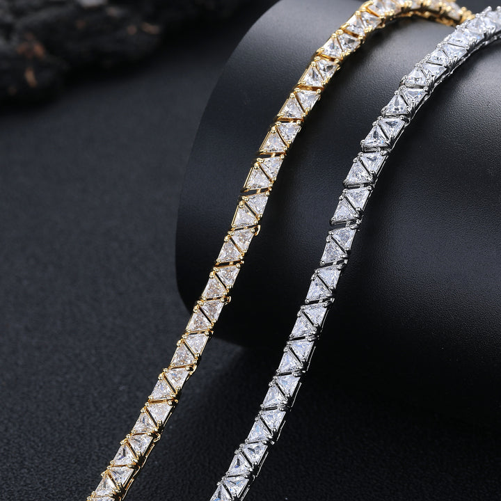Close-up of triangular stones in silver- and gold-tone necklaces on a black bust