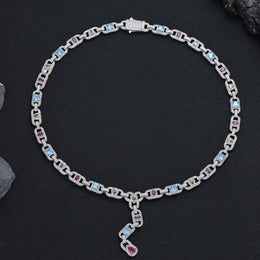 Silver-tone multicolor lariat necklace arranged in a circle on black fabric
