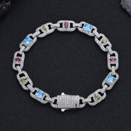 Silver-tone multicolor geometric link bracelet resting on black fabric