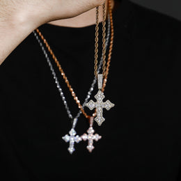 Gold iced vintage cross pendant handheld detail