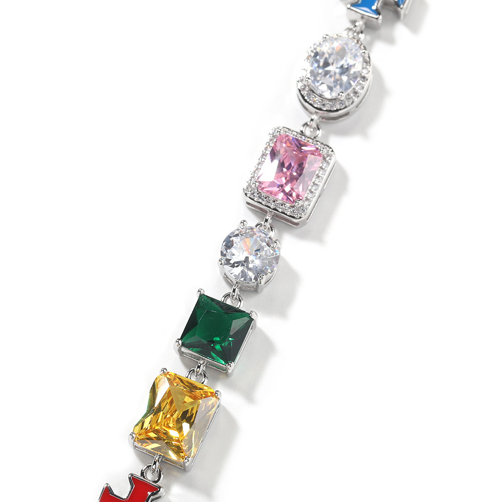 Close-up of pink, clear, green and yellow faceted stones in silver-tone settings