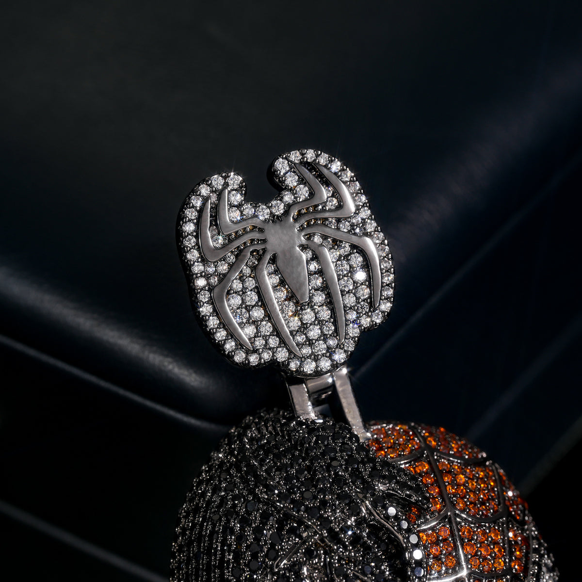 Close-up of the stone-set spider-shaped bail and split-face pendant