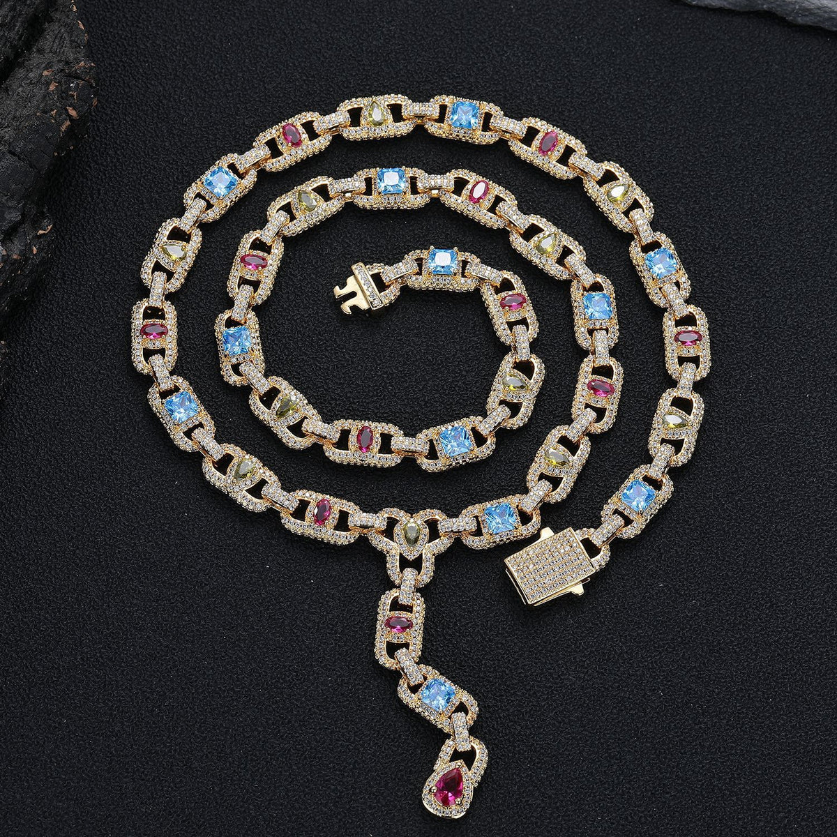 Gold-tone multicolor lariat necklace coiled on black fabric with its clasp open
