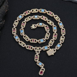 Gold-tone multicolor lariat necklace coiled on black fabric with its clasp open