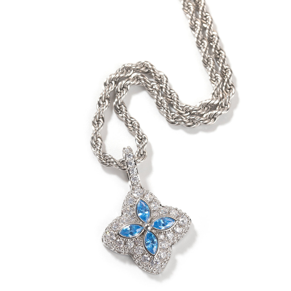 Aqua-blue four-leaf clover pendant in a silver-tone setting on white
