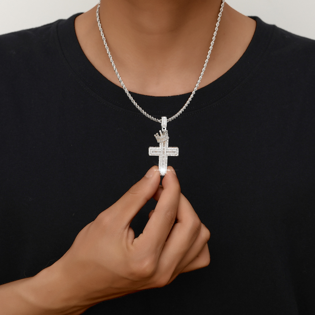 Silver iced crown cross pendant worn by a deep brown skin model