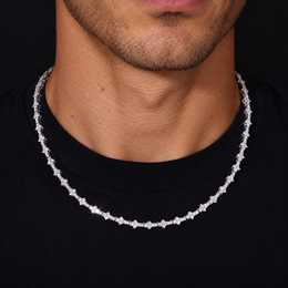 Adult model wearing a silver-tone moissanite tennis necklace over a black crew-neck shirt