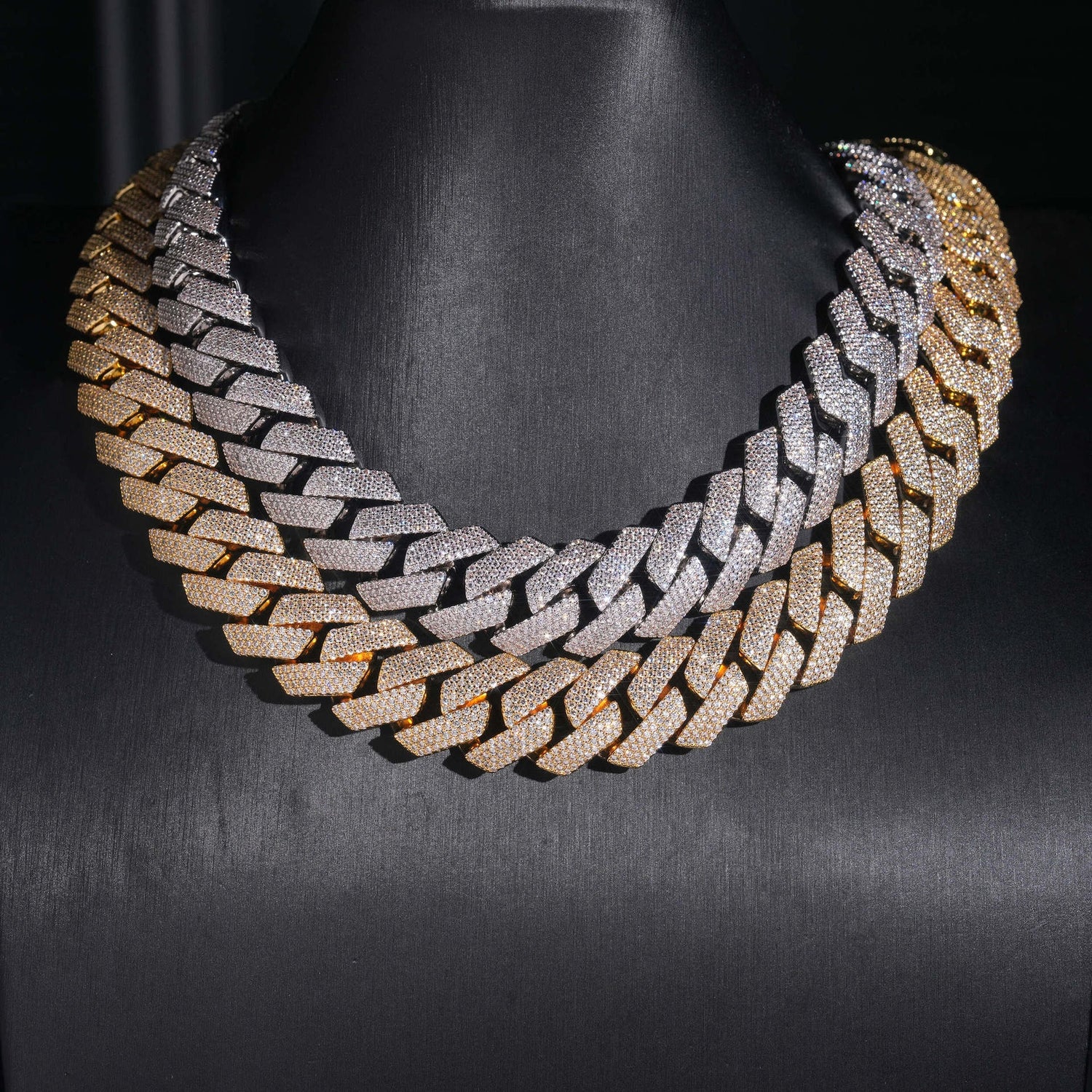 Silver and gold 4-row iced Cuban chains displayed on a black bust