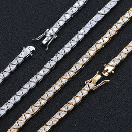 Open box clasps and triangular stones in silver- and gold-tone settings