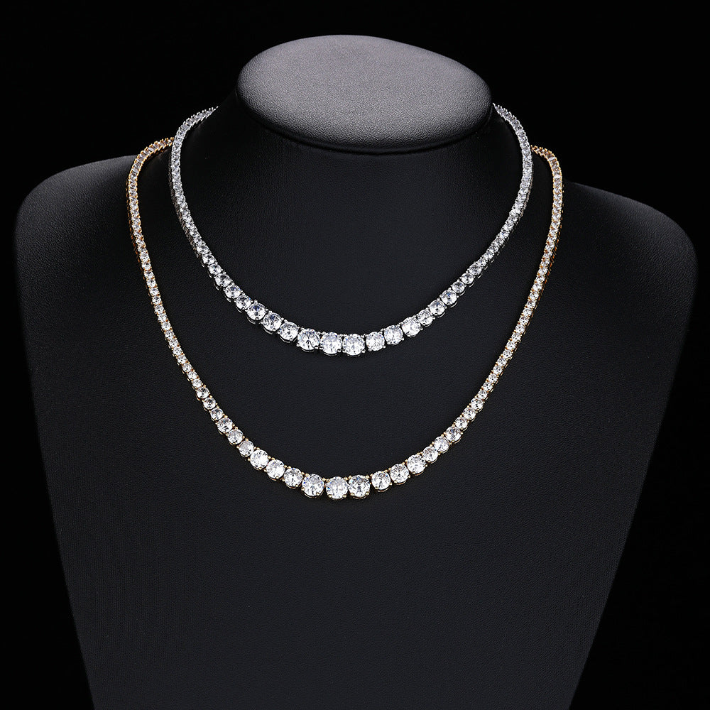 Silver- and gold-tone graduated tennis necklaces draped on a black bust