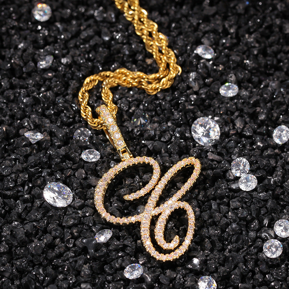 Gold-tone cubic zirconia script letter C pendant on black stones