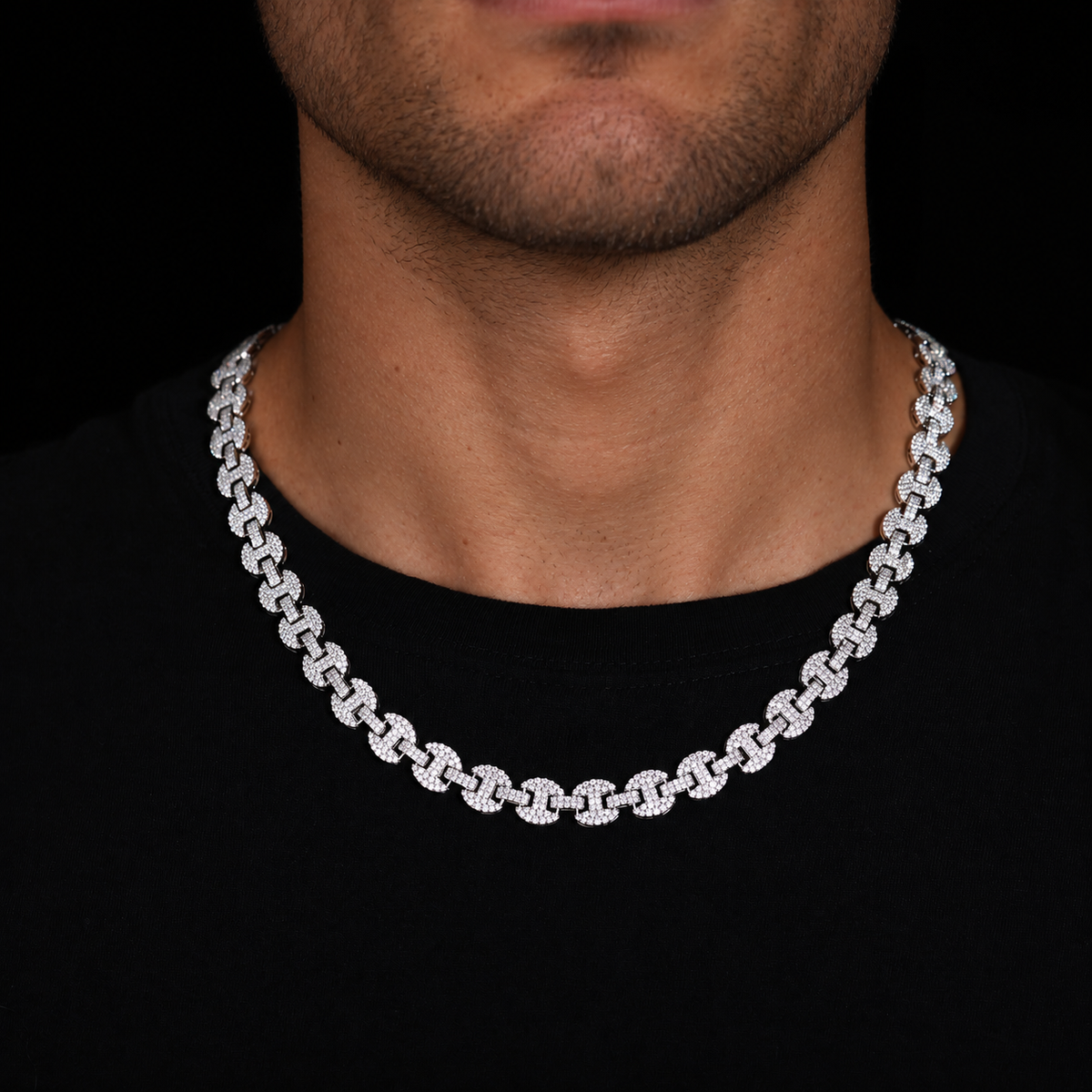 Adult model wearing a silver-tone moissanite mariner link chain over a black shirt