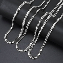 Silver 3mm Franco Chain links arranged on black fabric
