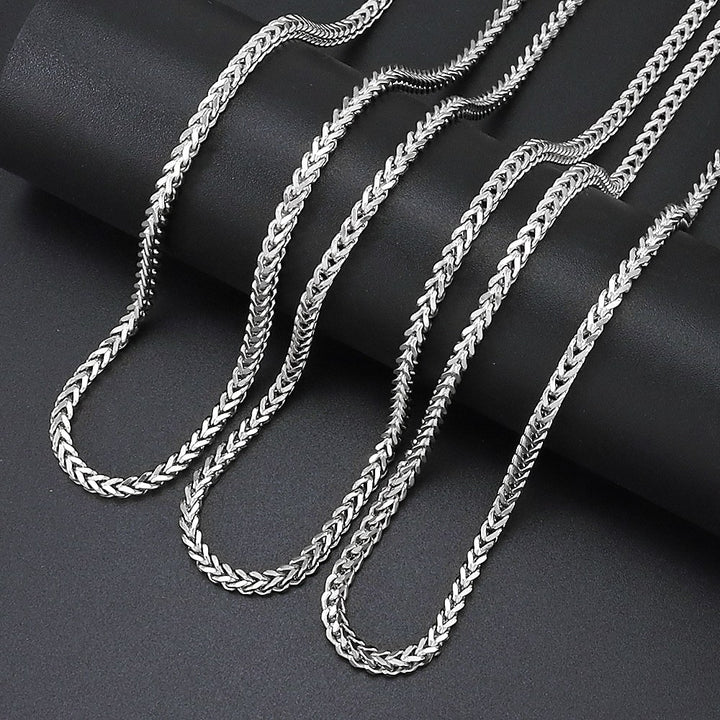 Silver 3mm Franco Chain links arranged on black fabric