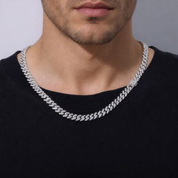 Adult model wearing a silver-tone moissanite Cuban chain with a clasp near the shoulder