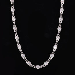 Round moissanite halo links alternating with slim connectors in a U-shaped drape on black