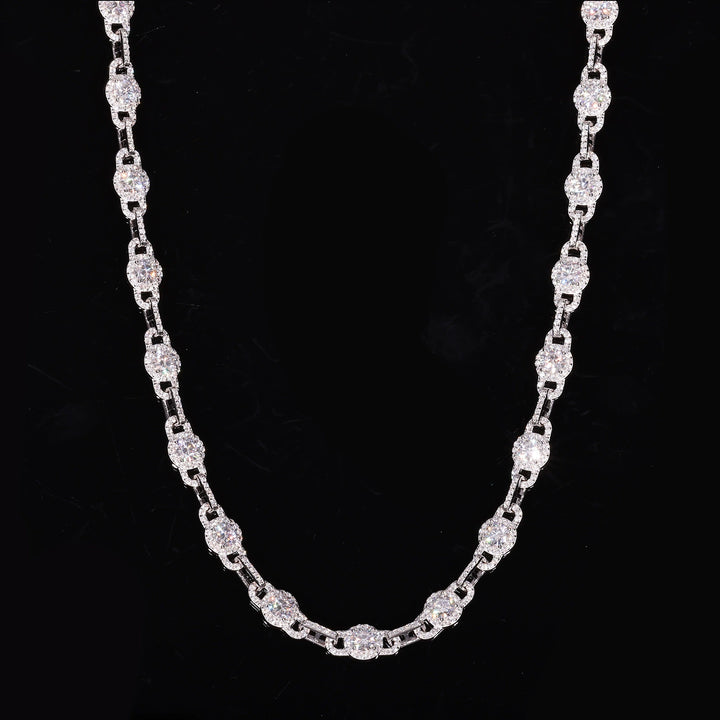 Round moissanite halo links alternating with slim connectors in a U-shaped drape on black