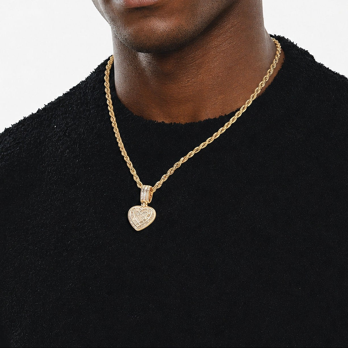 Gold baguette iced double heart pendant worn by a deep-brown model