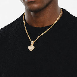 Gold baguette iced double heart pendant worn by a deep-brown model