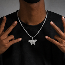 Mini solid iced butterfly pendant worn by a deep-brown model