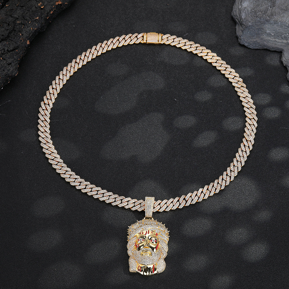 Gold-tone iced Crown of Thorns Jesus pendant laid flat on black