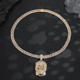 Gold-tone iced Crown of Thorns Jesus pendant laid flat on black