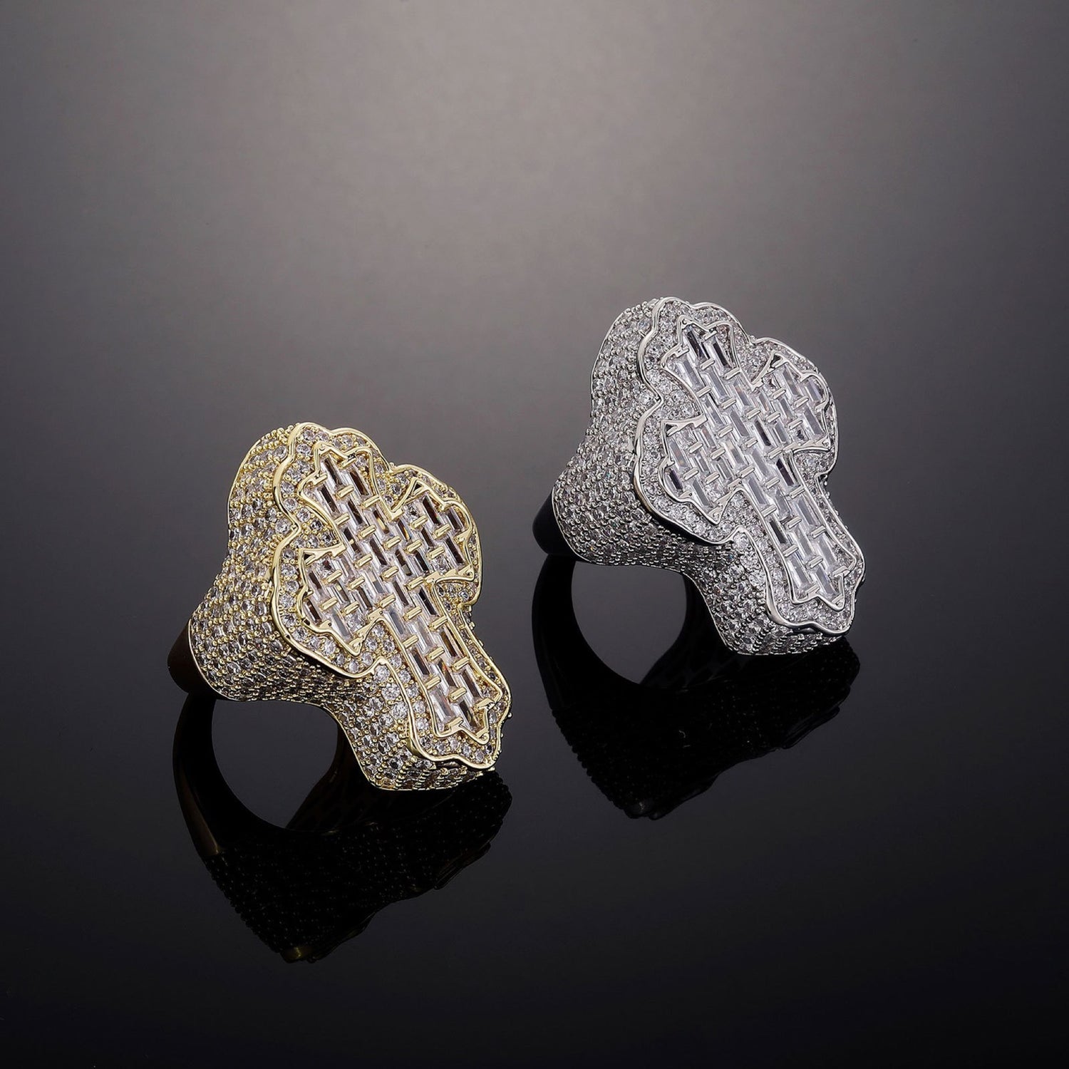 Gold and Silver iced cross statement rings on black
